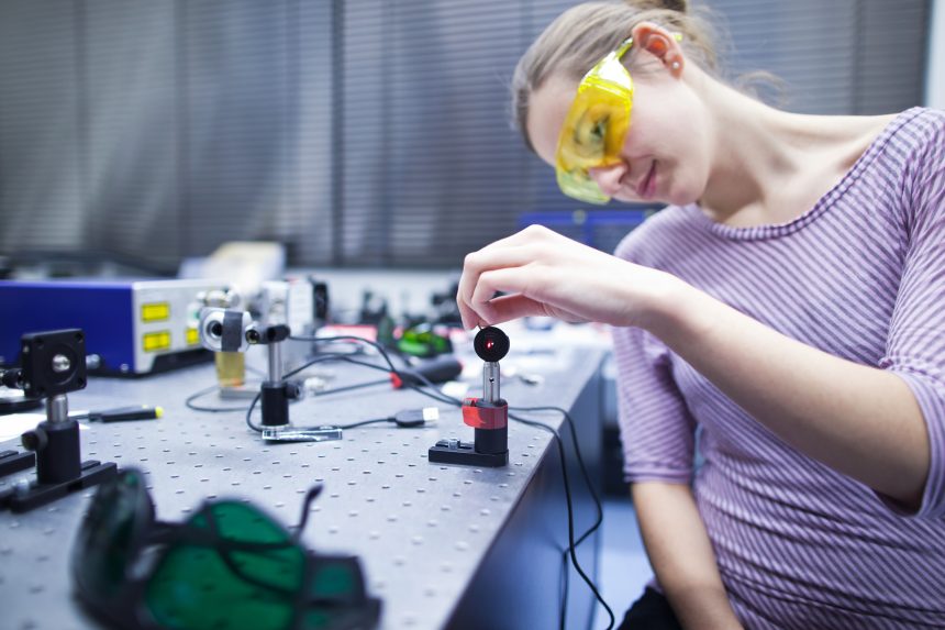 An A Level physics student building a circuit.