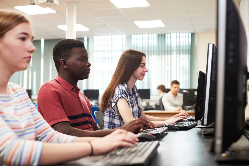 Three sixth form students in A Level IT class.