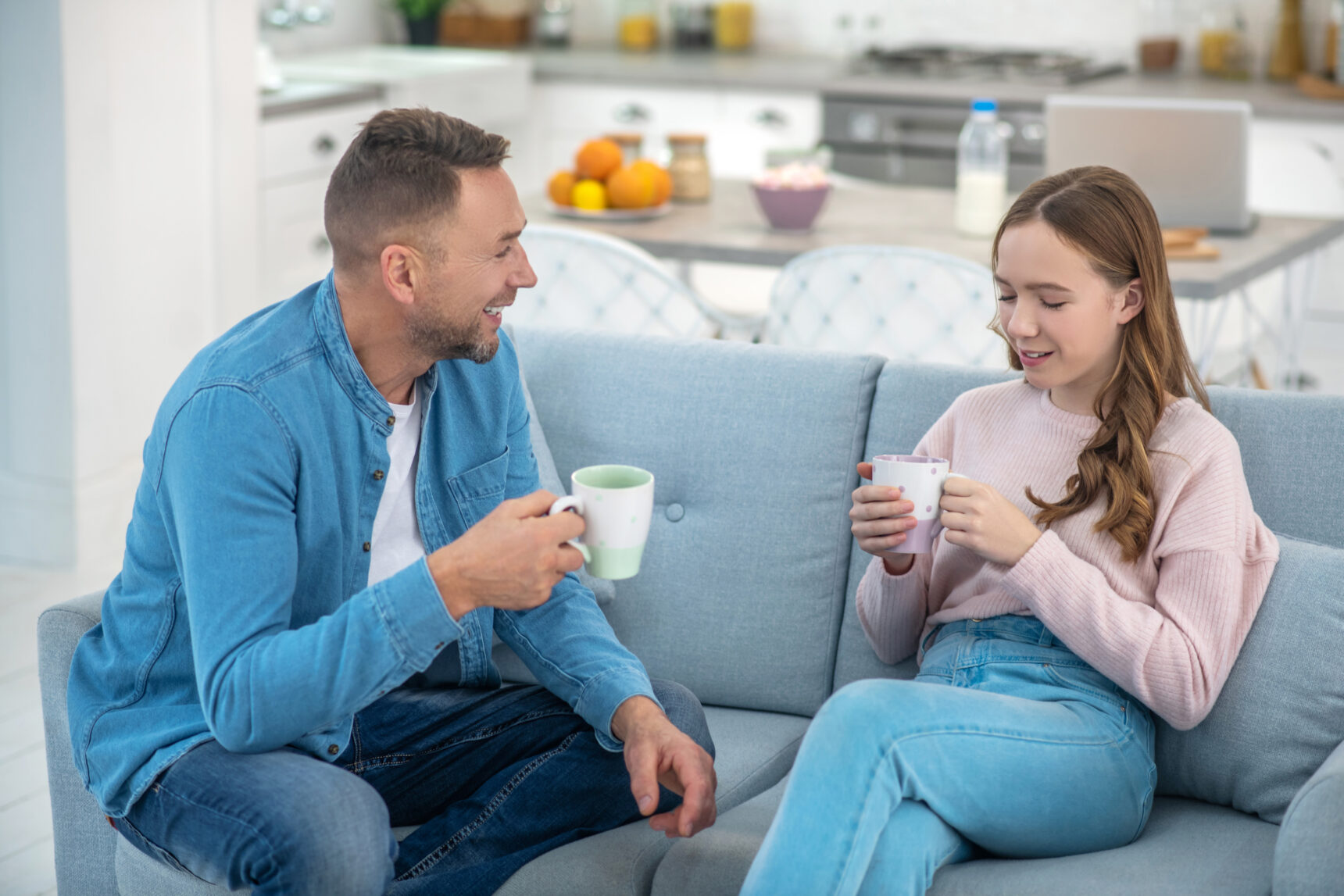 A teenage girl and her Dad are sitting on the sofa drinking tea and discusing next steps after GCSE Results Day 2026.