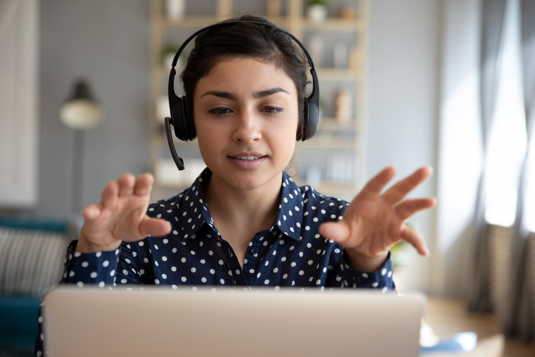 A female tutor is delivering an online lesson to support a student with exam preparation.