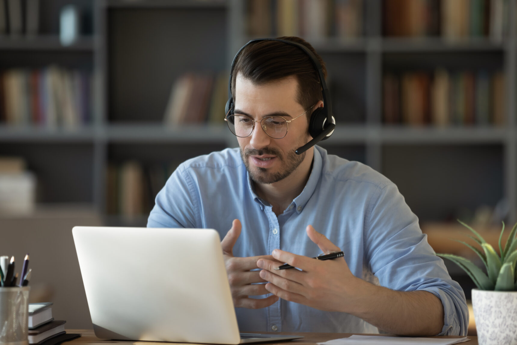 A male online tutor is speaking to a student during a lesson before exams.