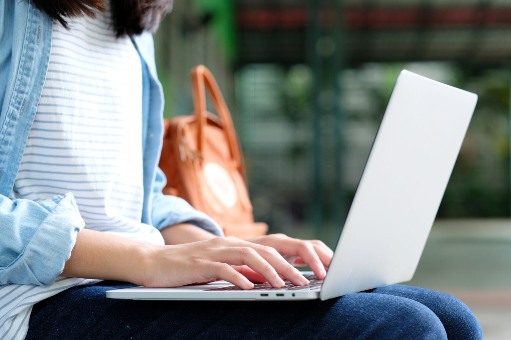 An online tutor is replying to messages from a student on a laptop.