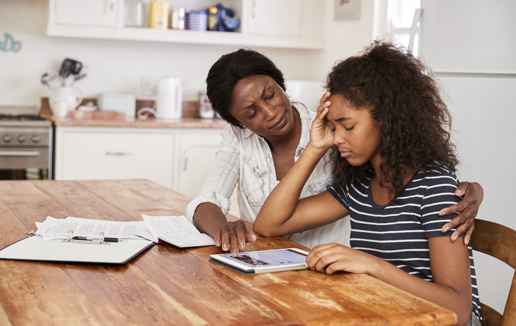 A mother is supporting her anxious teenage daughter during exam season.